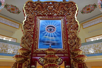 Hoi An, Vietnam, November 19, 2020: The richly decorated All-Seeing Eye in the main hall of worship of Hoi An Cao Dai Temple