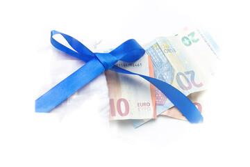 Hundred euro banknotes on a stack with red bow. Gift, bonus or reward concept