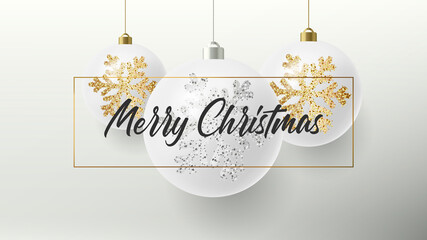 Merry Christmas greeting card or poster with white realistic Christmas balls hanging in a frame with calligraphy copy and golden and silver snowflakes illustration sparkle on them