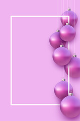 Fototapeta premium Vertical frame with pink christmas tree balls hanging on strings.