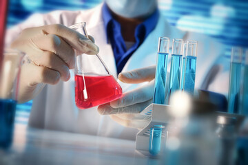 Detail of scientist manipulating carefully a flask on a laboratory