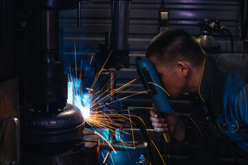 welding torque converter parts in a workshop sparks