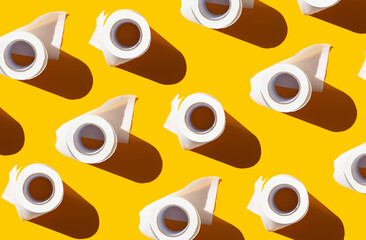 white rolls of toilet paper on a bright yellow background. personal hygiene items for diarrhea....