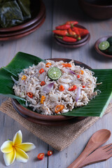 Ayam suwir sambal matah is a Balinese or Indonesian cuisine from spicy chunks of chicken meat with sliced of shallot and cayenne mix with shrimp paste, served on banana leave.