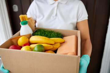 Courier with packing box with food, contactless delivery