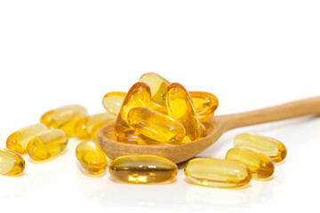 Omega 3 gel capsules in a wooden spoon