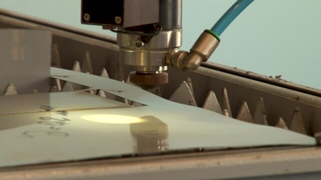 Technological process of laser cutting of metal sheet from titanium alloys on installation. Aviation. Repair of gas turbine engines. Close-up.
