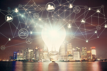 Multi exposure of bulb hologram drawing and cityscape background. Concept of idea.