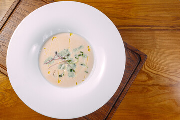 cream soup in a plate on a wooden table