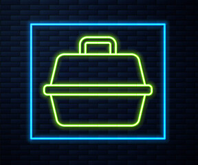Glowing neon line Pet carry case icon isolated on brick wall background. Carrier for animals, dog and cat. Container for animals. Animal transport box. Vector.