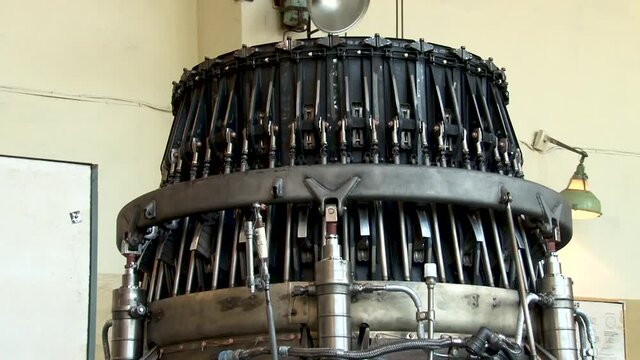 Repair of gas turbine engines with afterburner.  Checking operability of control system of shutters of jet nozzle of aircraft engine on stand in factory. Close-up. Aircraft engines. 
