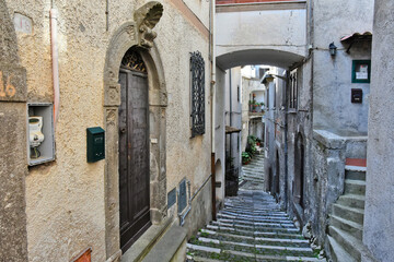 Obraz premium A narrow street among the old houses of Patrica, a medieval village in the Lazio region, Italy. 