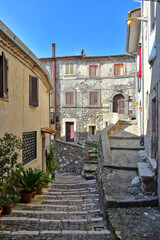 Fototapeta na wymiar A narrow street among the old houses of Patrica, a medieval village in the Lazio region, Italy. 