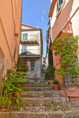 Fototapeta na wymiar A narrow street among the old houses of Patrica, a medieval village in the Lazio region, Italy. 