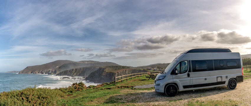 camper van parked high up on cliffs of a wild and rugged coastline