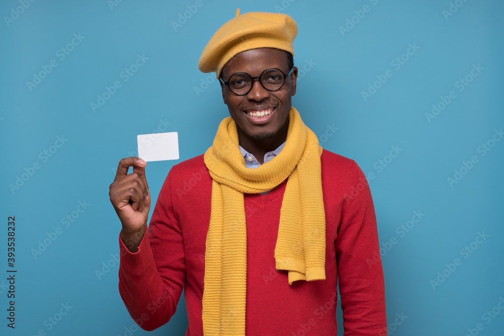 Wall mural African American man holding a empty business card smiling. Advertise services concept.