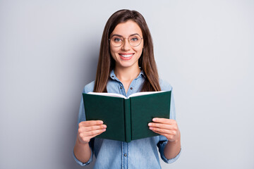 Photo of optimistic pretty long hairdo lady reading copybook wear spectacles blue cloth isolated on grey color background