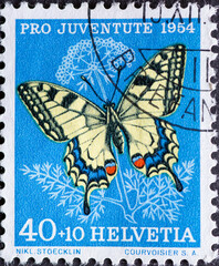 Switzerland - Circa 1954 : a postage stamp printed in the swiss showing a swallowtail butterfly...