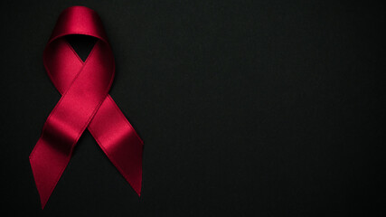 Hiv support. Red ribbon symbol in hiv world day on black background. Awareness aids and cancer....