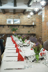 Medieval room with a big table prepared and decorated for the guest .