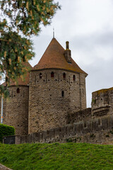 Fototapeta na wymiar Fortifications of the medieval city of Carcassonne, France. The Narbonnaise gate, was built around 1280 during the reign of Philip III the Bold and was made up of two enormous spur towers.