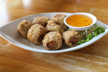 Deep-fried oysters with sweet dipping sauce ready to serve.