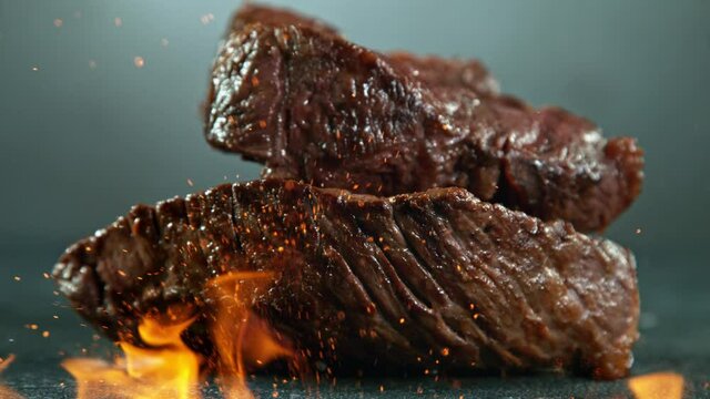 Close-up of falling tasty beef steak, super slow motion, filmed on high speed cinematic camera at 1000 fps.