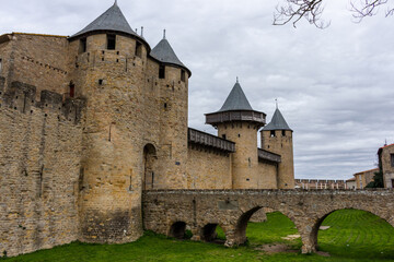 Fototapeta na wymiar The Château Comtal - entrance from the Cité of Carcassonne, France. The chateau of the Counts of Carcassonne and the ramparts, a UNESCO World Heritage site located at the heart of the fortified city.