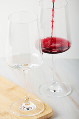Red wine pouring to a white glass