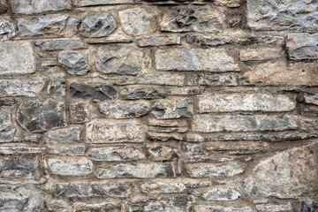 Grey color old stone wall texture background. Stone mason craft example