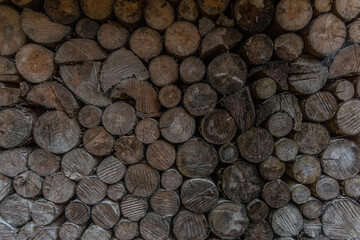 stacked round firewood in the mountains