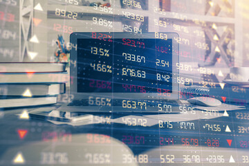 Financial chart drawing and table with computer on background. Double exposure. Concept of...