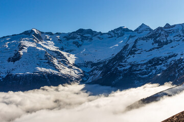 Snow and mountain peaks in the french Pyrenees near the Luchon Superbagnères Ski Resort in the Arrondissement of Saint-Gaudens, Occitania, Haute-Garonne, France. The Luchonnais Mountains aerial view.