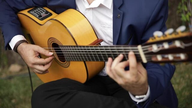 Guitarist playing at a wedding. Close up. Slow motion video