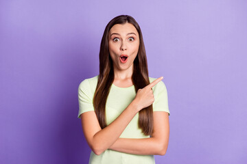 Photo of astonished person indicate finger empty space open mouth disbelief isolated on pastel magenta color background