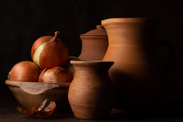 Still life with old ceramic and raw onion dishes © Galina Semenko