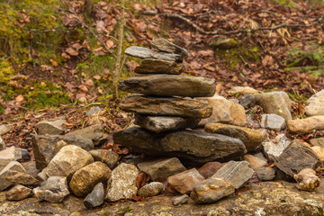 Balanced cairn or troll stoned pyramid, tourist memory sign or hiking path marking at the Valley Val d’Astau, southwest of Bagneres de Luchon in the French Pyrenees. The trail to Lake d'Oô, France.