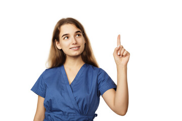 Young beautiful female doctor in a blue surgical gown shows a finger to the side isolated on a white background. Copspace