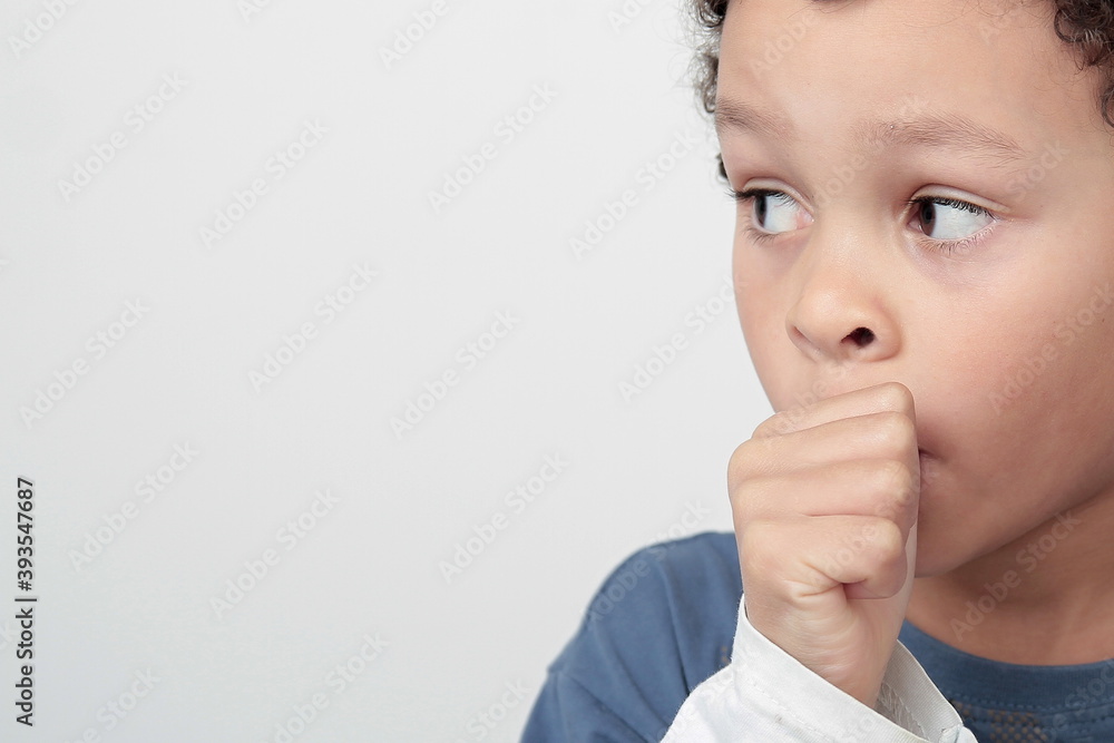 Wall mural little boy sucking thumb on white background stock photo