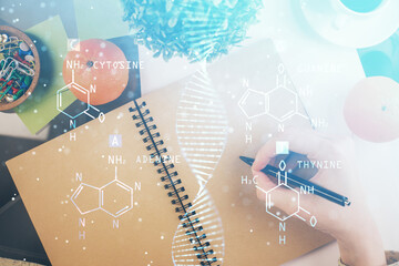 DNA theme hologram over woman's hands writing background. Concept of education. Double exposure