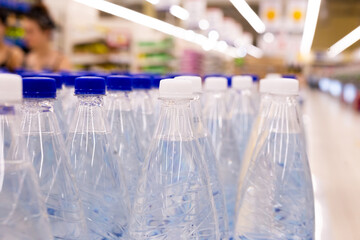 water bottles with blue caps in supermarket