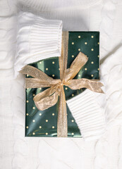 beautiful green gift box with bow knot on white sweater