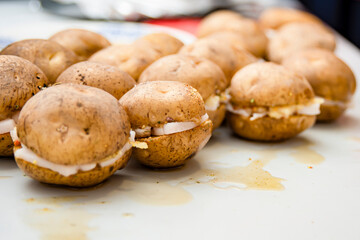There are several raw potatoes on the table, ready to be fried.