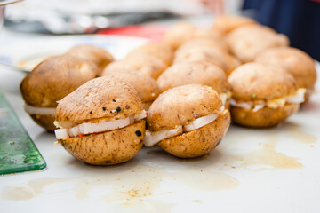 There are several raw potatoes on the table, ready to be fried.