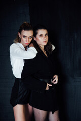 Two beautiful fashionable female girlfriends together brunette and blonde