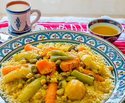 Moroccan Couscous with Chicken and Vegetables on Traditional Dishes Accompanied by a Great Cup of Fermented Whey, Lben.