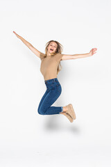 Portrait of a cheerful woman jumping isolated on a white background