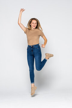 Portrait Of A Cheerful Woman Jumping Isolated On A White Background