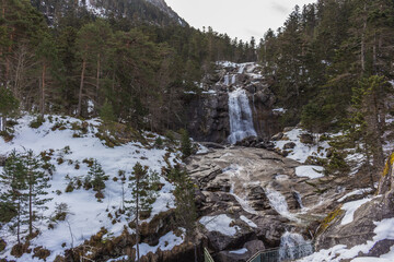 The Pont d’Espagne bridge on the river Gave du Marcadau and the waterfalls of cascade du Pont d’Espagne (river Gave du Gaube) in Cauterets, France. © An Instant of  Time