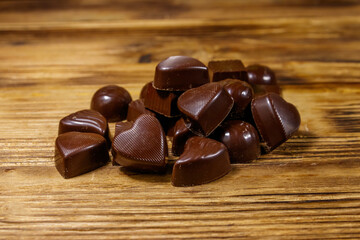 Tasty chocolate candies on wooden table